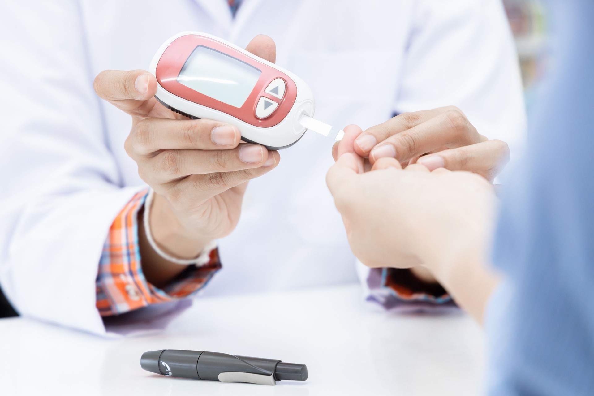 Pharmacist in pharmacy determines blood glucose level for insulin determination in patient, Sample blood analysis to determine blood group.